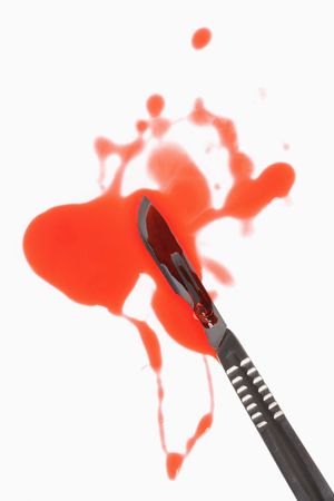 Medical scapel with fake blood around it.の写真素材