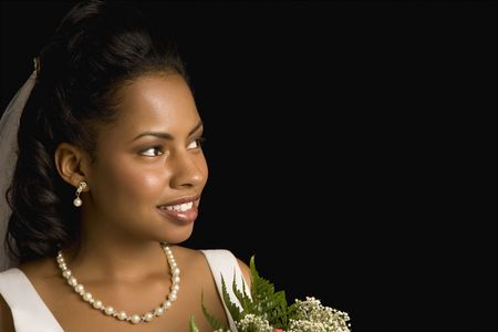 Portrait of a mid-adult African-American bride holding bouquet.の写真素材