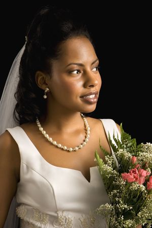 Portrait of a mid-adult African-American bride on black background.の写真素材