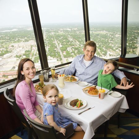 Caucasian family having dinner together at Tower of Americas restaurant in San Antonio, Texas.の写真素材