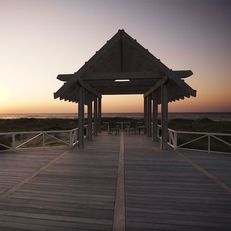 Gazebo at North Carolina coast with setting sun in background.の写真素材