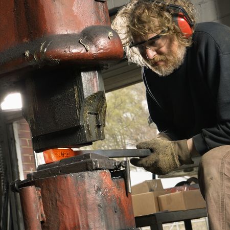 Caucasian man using power hammer.の写真素材
