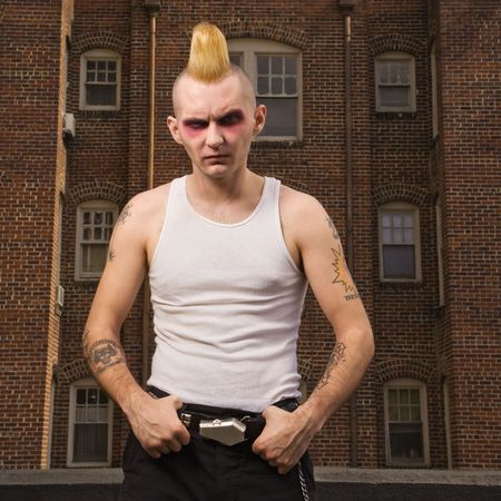 Portrait of a mid-adult Caucasian male punk ouutside with building in background.の写真素材