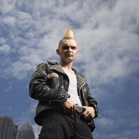 Portrait of mid-adult Caucasian male punk with skyline in background.の写真素材