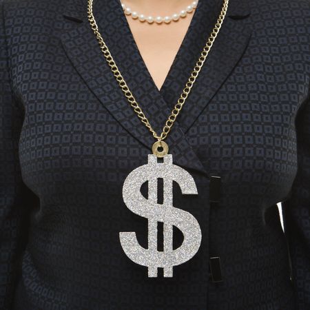 Close-up of Filipino middle-aged businesswoman wearing chain necklace with oversized dollar sign.の写真素材