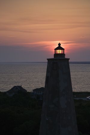 Lighthouse at sunset on Bald Head Island, North Carolina.の写真素材