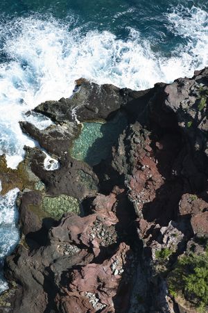 Aerial view of waves crashing on rocks in Maui, Hawaii.の写真素材