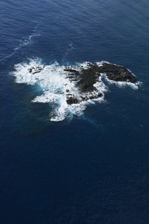 Aerial of rock in Pacific ocean off coast of Maui, Hawaii.