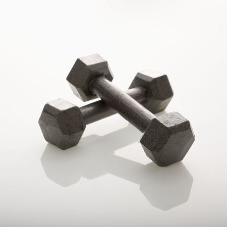Two dumbbells leaning together.の写真素材