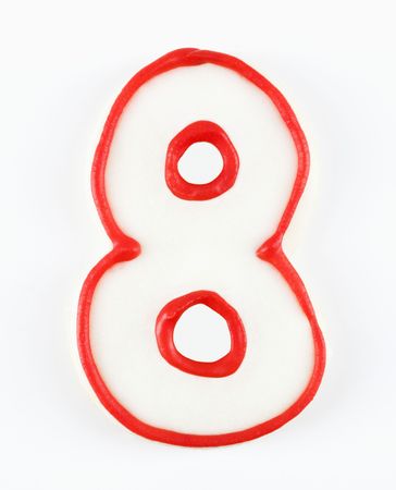 Sugar cookie in the shape of a number eight outlined in red icing.の写真素材
