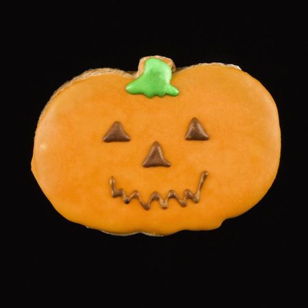 Sugar cookie in shape of pumpkin with decorative icing.の写真素材