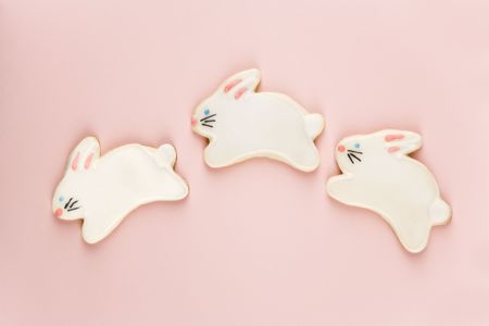Three bunny shaped sugar cookies with decorative icing.の写真素材