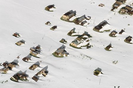 Aerial of snow covered buildings in small town, California, USA.