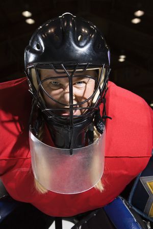 Woman hockey goalie wearing helmet sneering looking intimidating.の写真素材