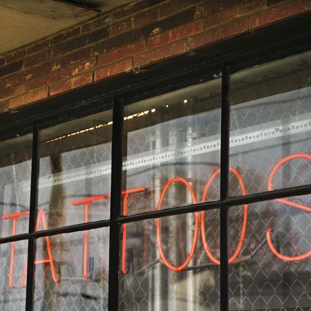 Neon sign in window for s and body piercing.