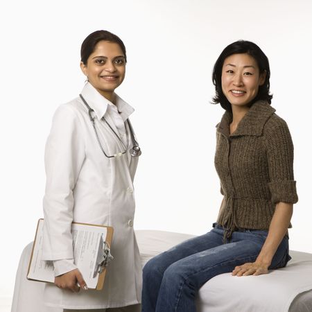Indian woman doctor with Asian woman patient.の写真素材