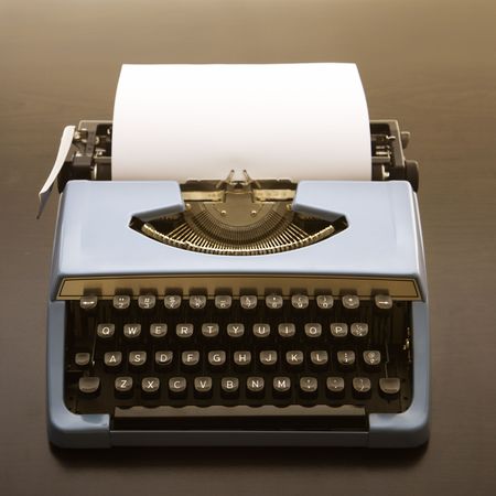 Still life of blank sheet of paper in an old fashioned typewriter.