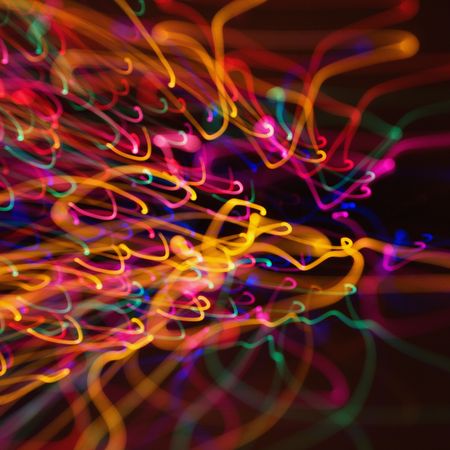 Multicolored lights forming abstract squiggle pattern from motion blur.の写真素材