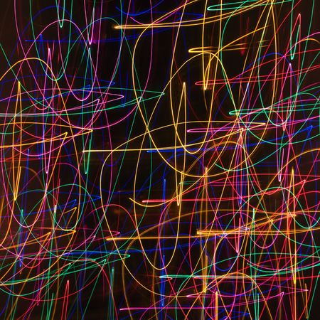 Multicolored lights forming abstract squiggle pattern from motion blur.