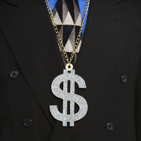 Man in suit wearing necklace with money sign.の写真素材