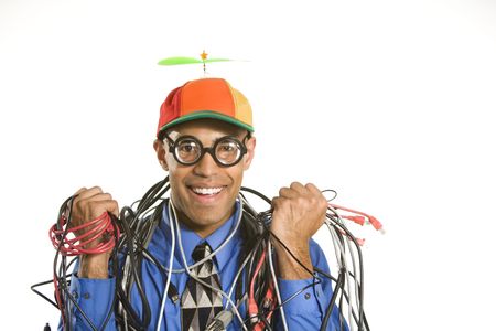African American businessman wrapped in computer cables wearing nerd hat and glasses.の写真素材