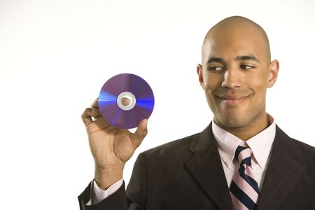 African American man smiling holding out compact disc.の写真素材