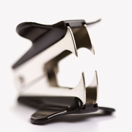Staple remover on white background with selective focus.の写真素材