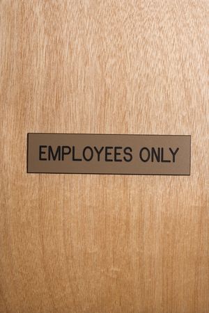 Employees only sign on wooden door.の写真素材