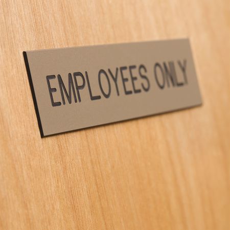Employees only sign on wooden door.の写真素材