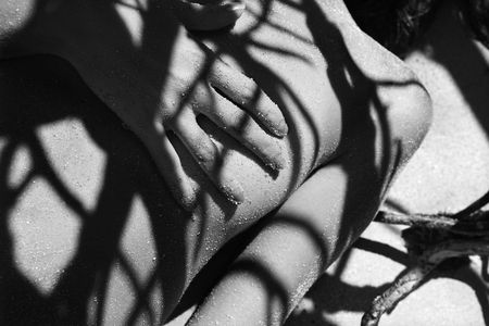 Pretty Filipino  young woman on beach in tree shadows in Maui, Hawaii.