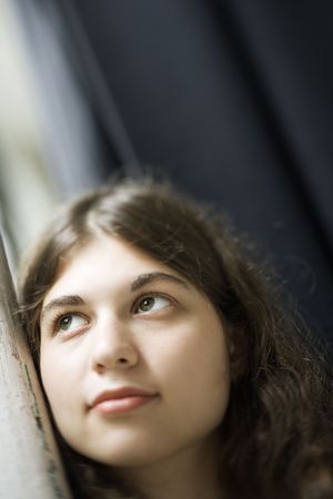 Selective focus of Caucasian young adult woman looking up.の写真素材