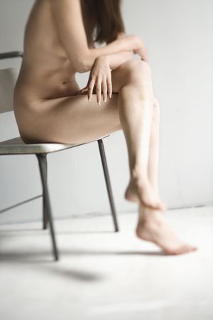 Nude woman sitting in chair.の写真素材