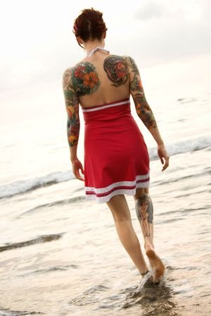 Attractive tattooed Caucasian woman on beach in Maui, Hawaii, USA.の写真素材