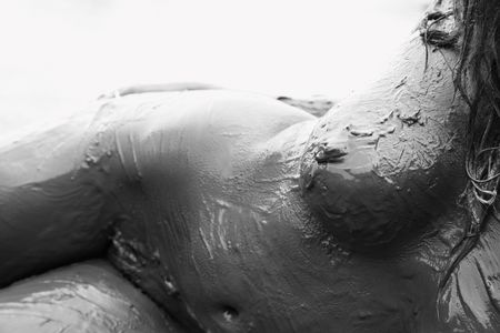 Young adult Caucasian female nude covered with mud.の写真素材