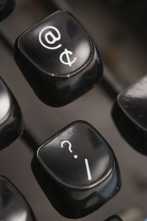 Close up of at sign and question mark levers on typewriter.の写真素材