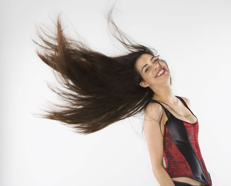 Caucasian woman wearing corset swinging her hair.の写真素材