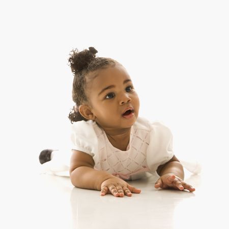 Portrait of African American infant girl against white background.の写真素材