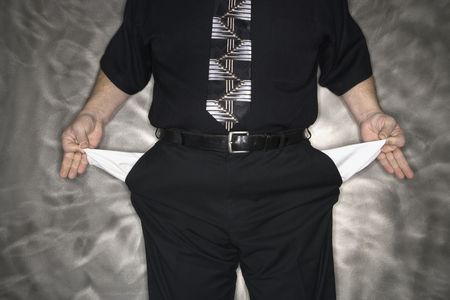 Caucasian mid adult man pulling out empty pants pockets.の写真素材