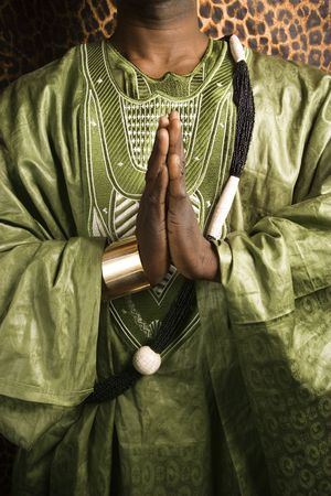 Close-up of African-American mid-adult man wearing traditional African clothing in prayer.の写真素材