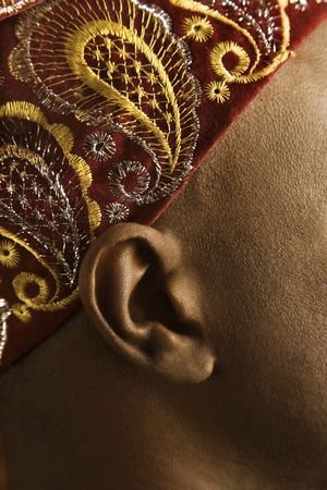 Close-up side view of African-American mid-adult man wearing traditional African hat.の写真素材