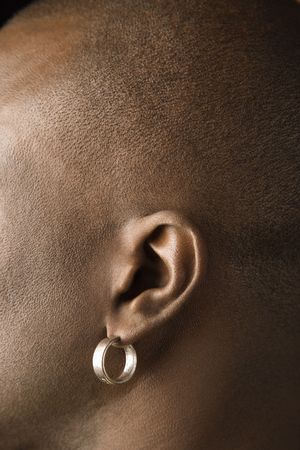 Side view portrait of African-American mid-adult man wearing earring.の写真素材