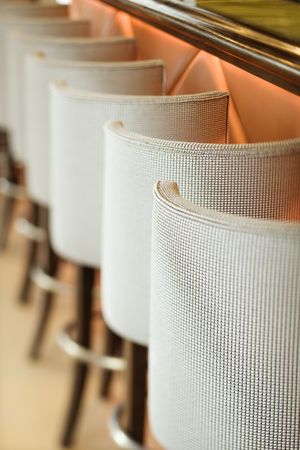 Stools lined up at bar.の写真素材