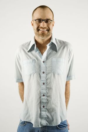 Portrait of smiling Caucasian man wearing eyeglasses standing against white background.の写真素材