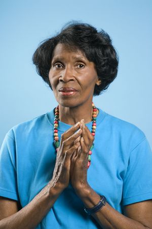 Prime adult female African American portrait with hands in prayer position.の写真素材
