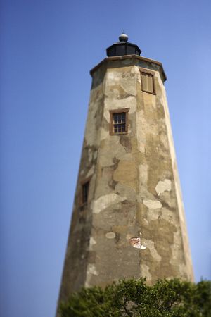 Worn and weathered lighthouse on Bald Head Island, North Carolina.の写真素材