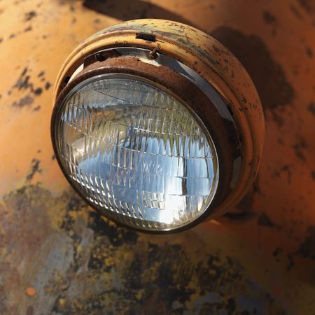 Close-up of headlight of scratched up rusty old pick-up truck.の写真素材