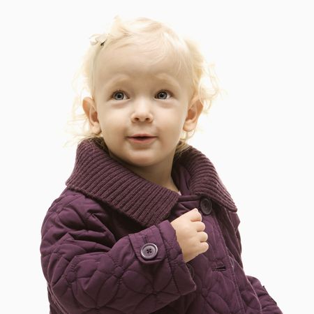 Portrait of young Caucasian female toddler wearing a purple coat.の写真素材