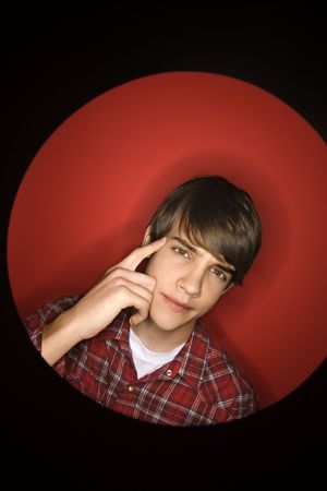 Portrait of Caucasian teen boy pointing to his head.の写真素材