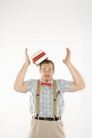 Caucasian young man dressed like nerd with books sliding off head.