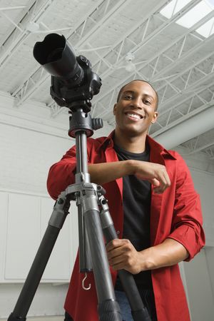 African American young male adult looking at viewer smiling.